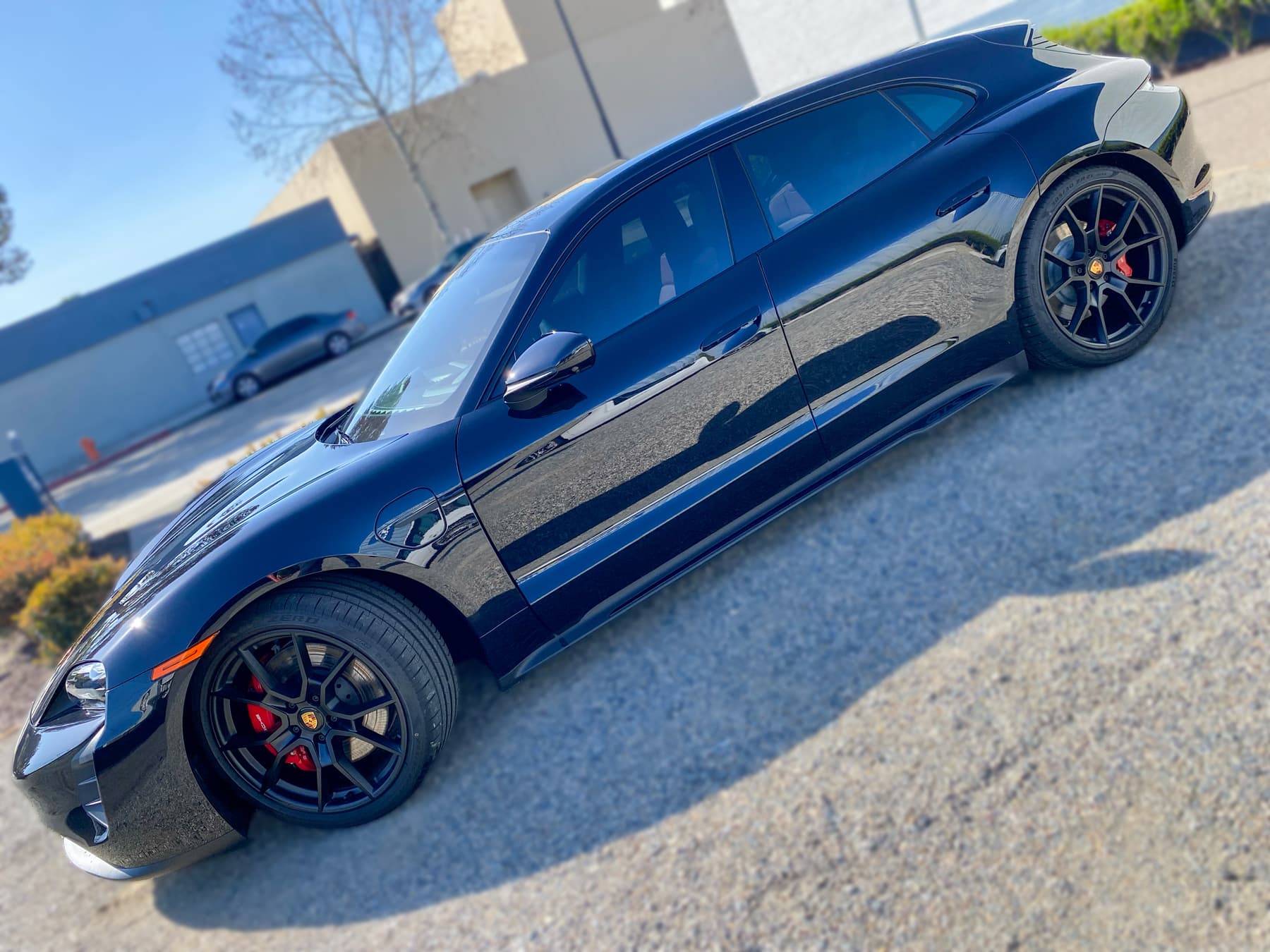 Black Porsche Taycan with automotive window tint