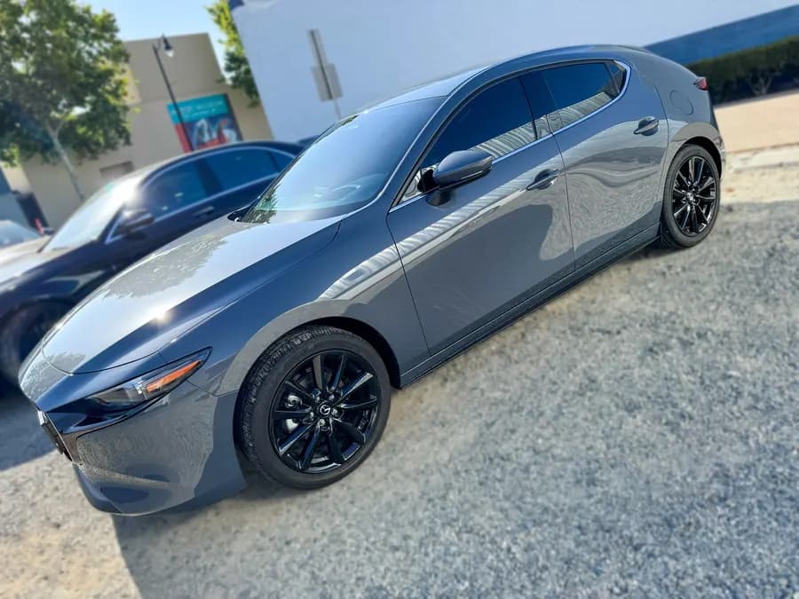 Gray Mazda 3 Hatchback side profile with tinted windows at OC House of Tint