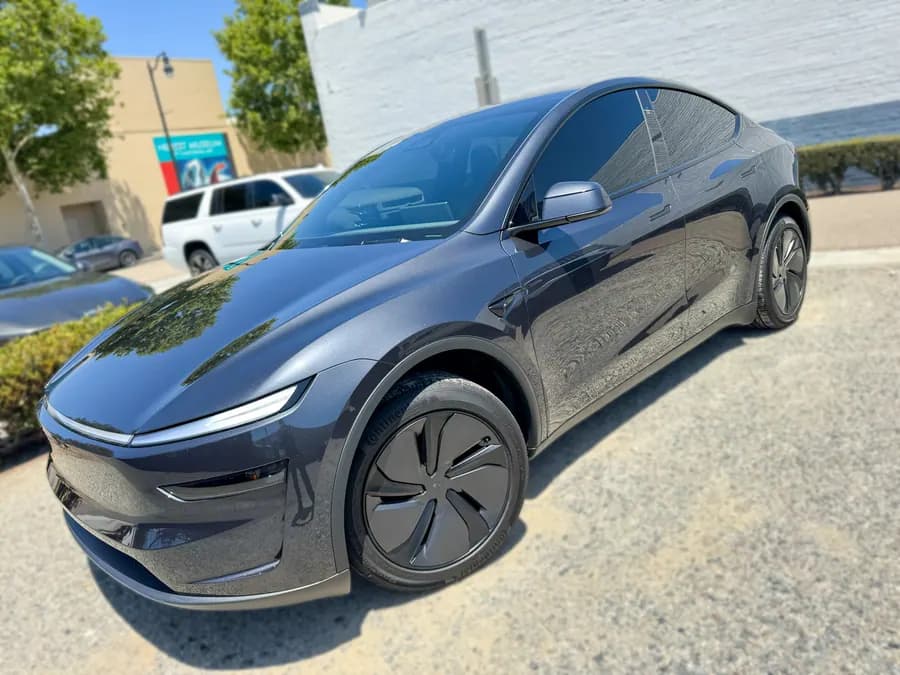 Dark gray Tesla Model Y with tinted windows at OC House of Tint