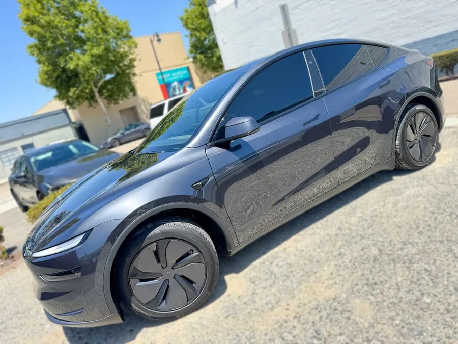 Dark gray Tesla Model Y side glass with window tint installed by OC House of Tint