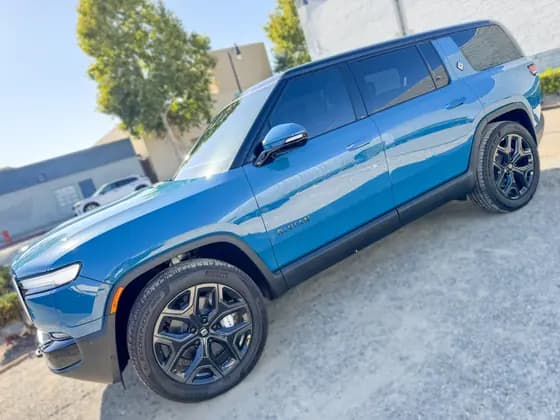 Blue Rivian R1S side windows and body profile at OC House of Tint
