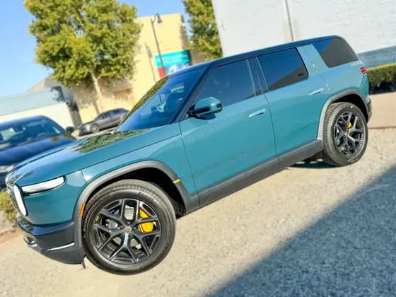 Teal Rivian R2 side profile with dark rear glass at OC House of Tint