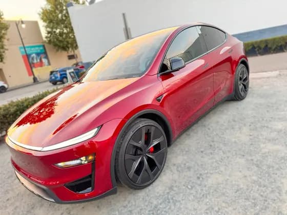 Red Tesla Model Y with dark side glass at OC House of Tint