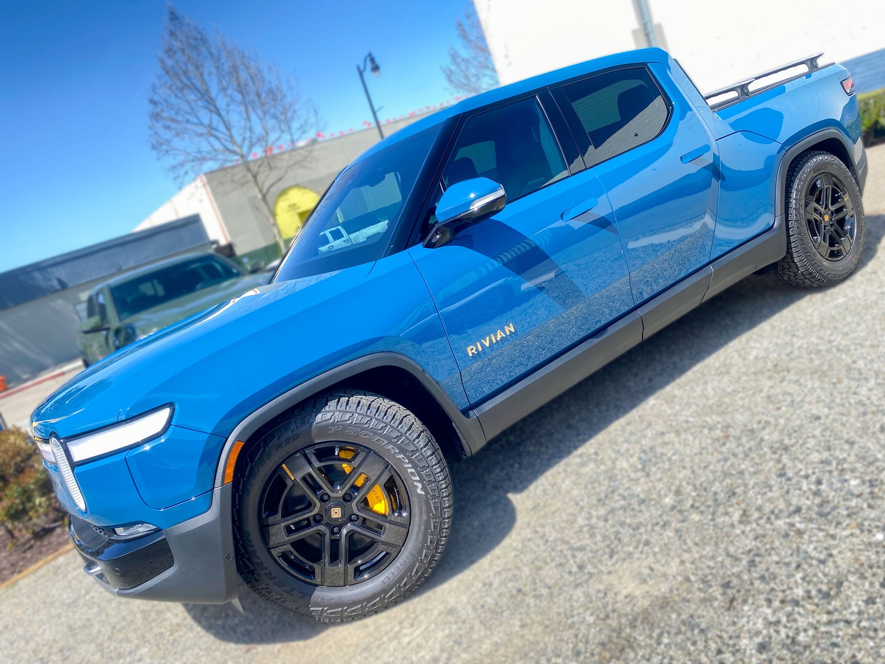 Blue Rivian R1T viewed along the driver side at OC House of Tint