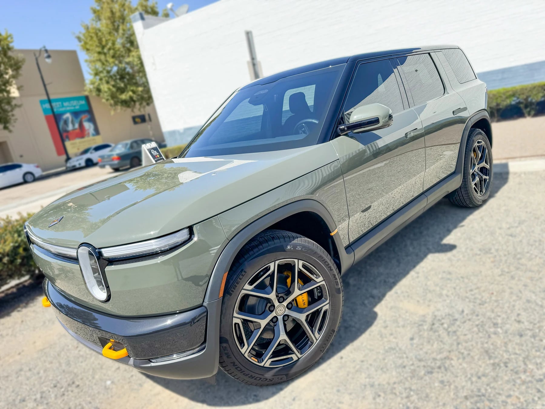 Front angle showing the green Rivian R2 windshield and tinted side windows