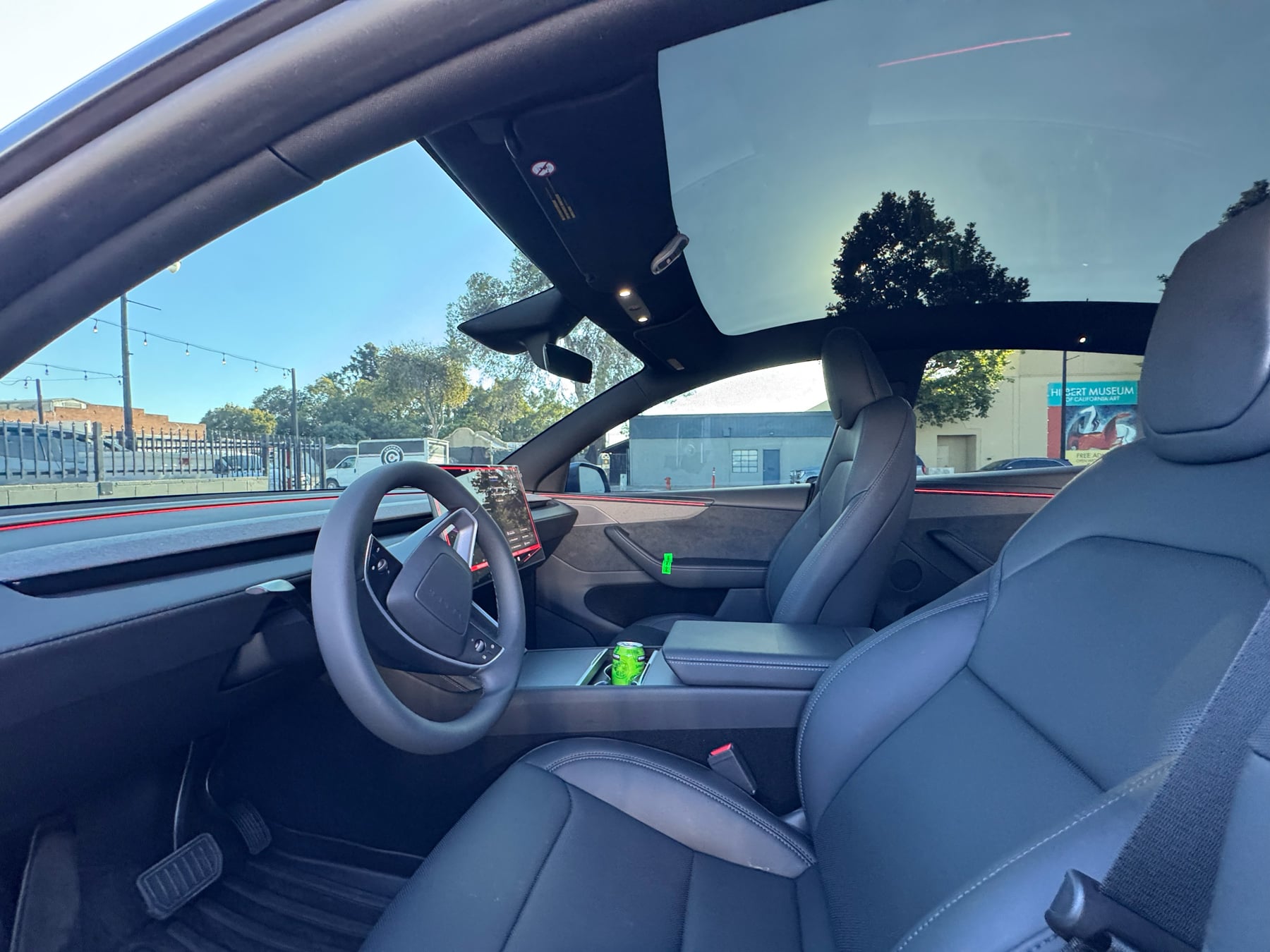 Tesla Model Y front cabin with side glass and panoramic roof visible