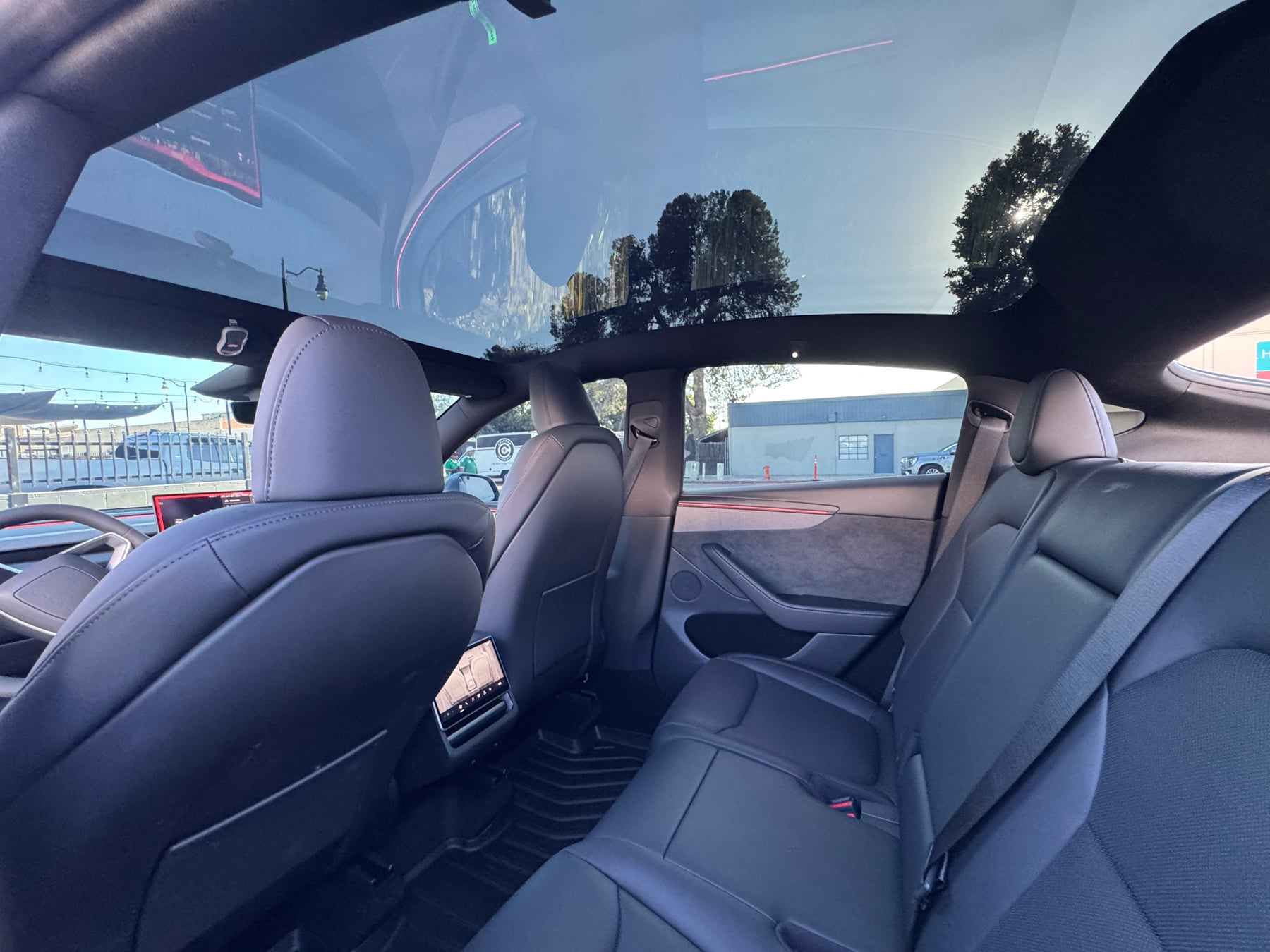 Tesla Model Y rear seat area showing side glass and panoramic roof