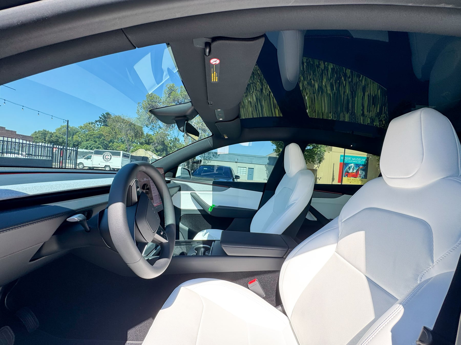 Tesla Model Y white cabin showing side glass and front seating