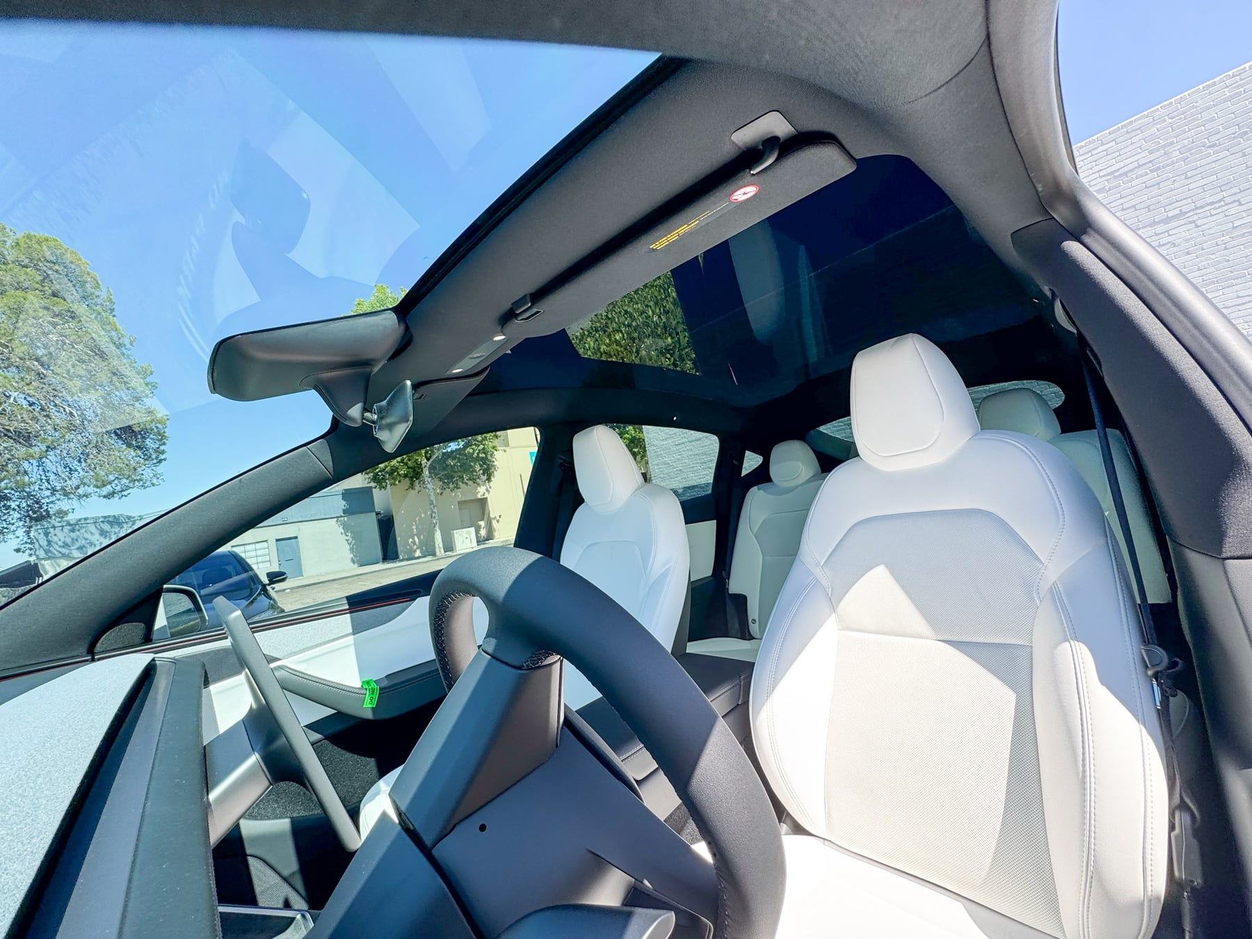 Tesla Model Y cabin view showing the windshield and panoramic glass