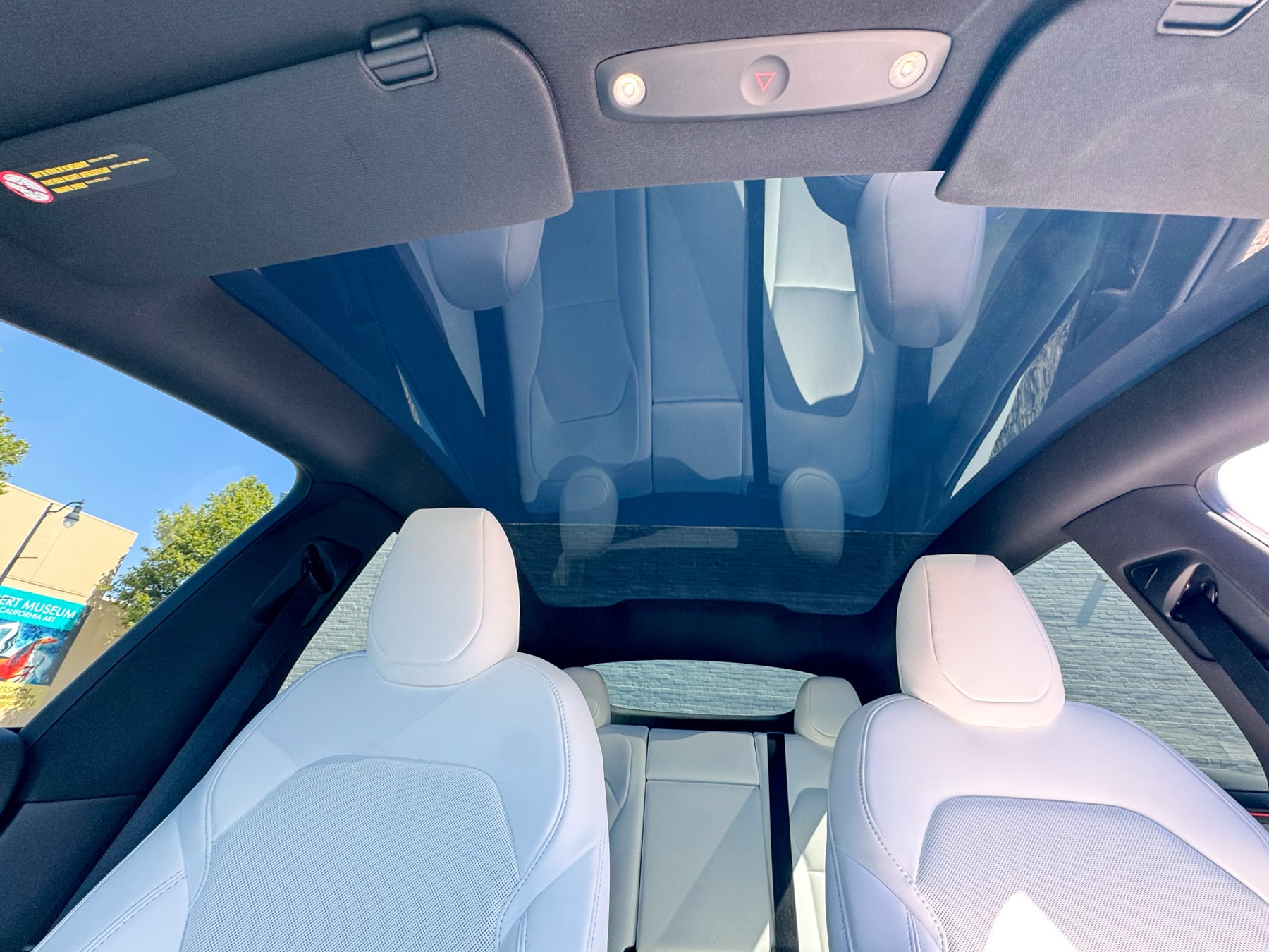 Tesla Model Y panoramic roof glass shown with 5% XPEL ceramic film for a darker roof-glass view and added cabin light control.