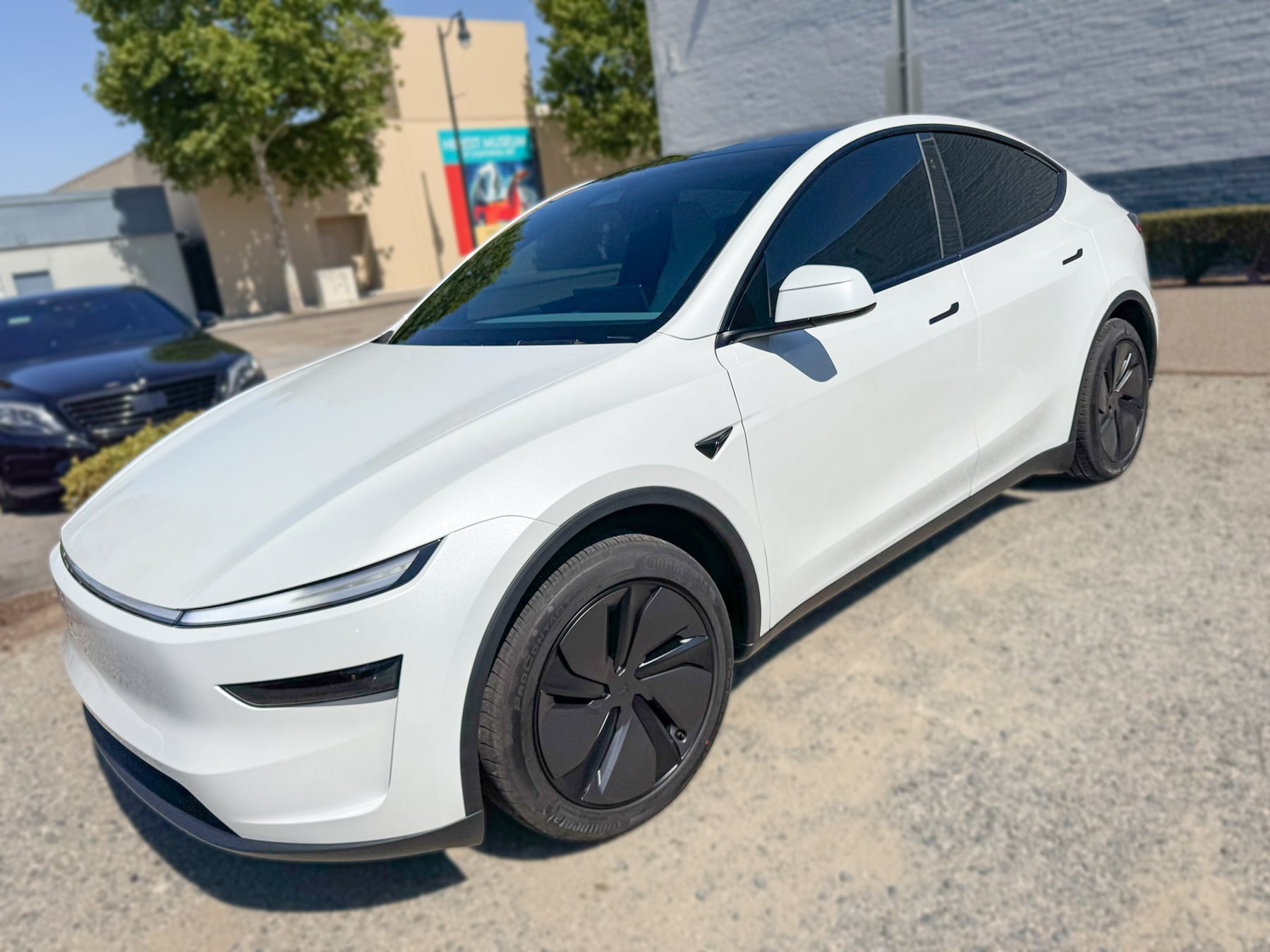 White Tesla Model Y with front light bar and window tint at OC House of Tint