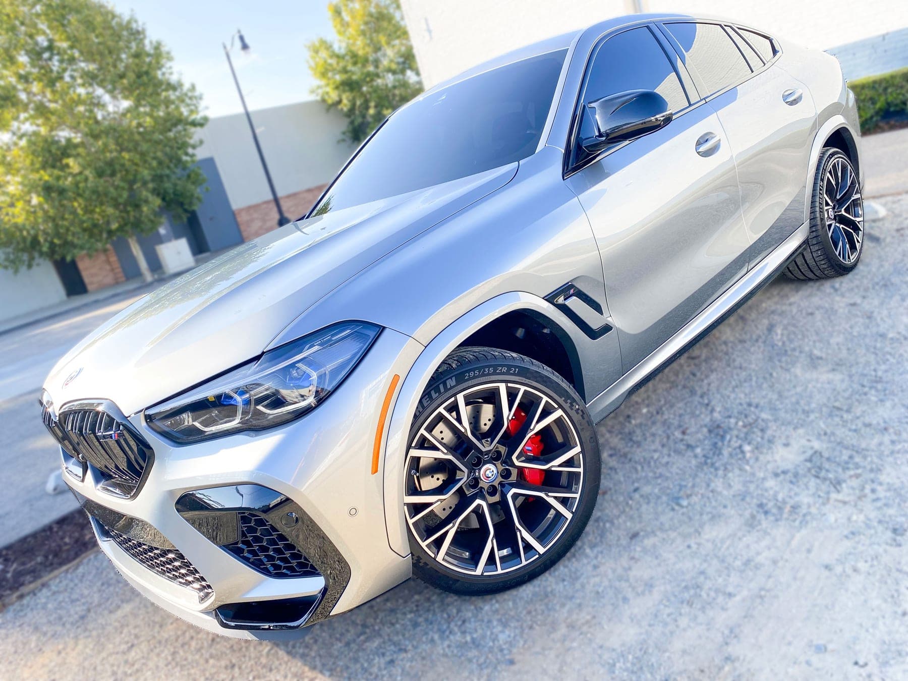 Silver BMW X6 M with ceramic window tint installed by OC House of Tint