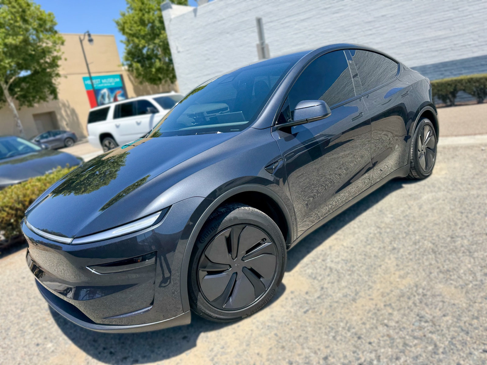 Dark gray Tesla Model Y front angle with window tint installed by OC House of Tint