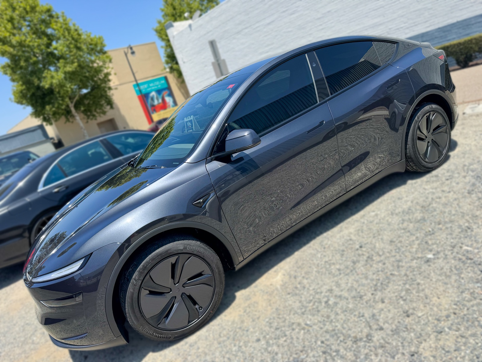 Dark gray Tesla Model Y side profile with window tint installed by OC House of Tint