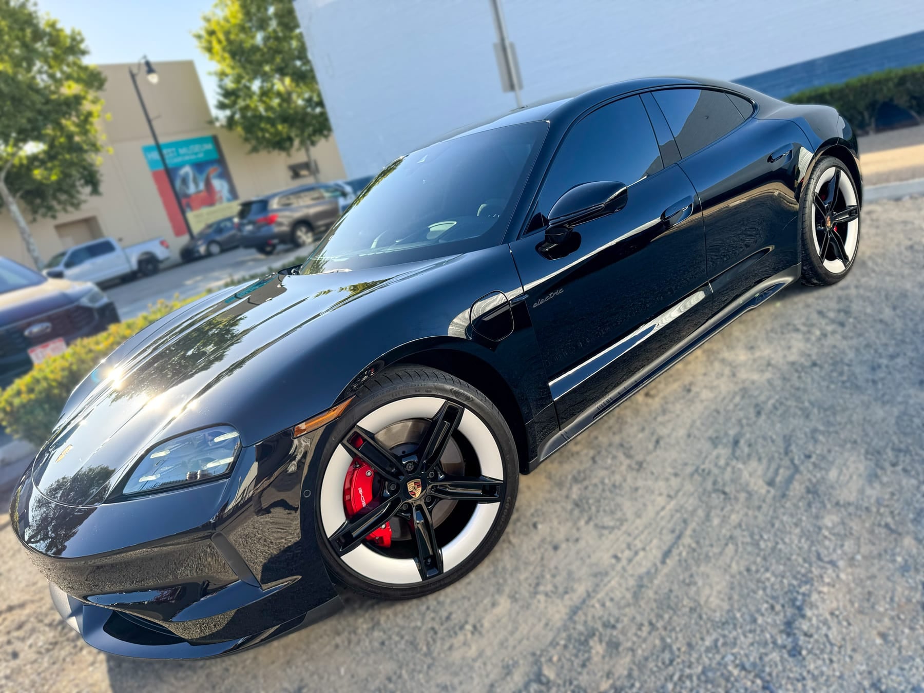 Black Porsche Taycan with tinted side windows at OC House of Tint